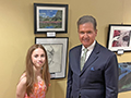  Kenmore East student poses with Congressman Brian Higgins for her award-winning artwork.